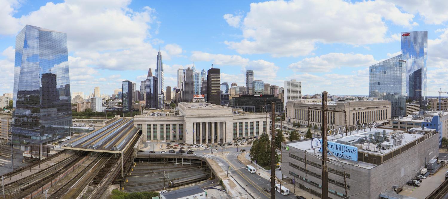 A panoramic view of the Philadelphia skyline with 30th Street Station in the foreground